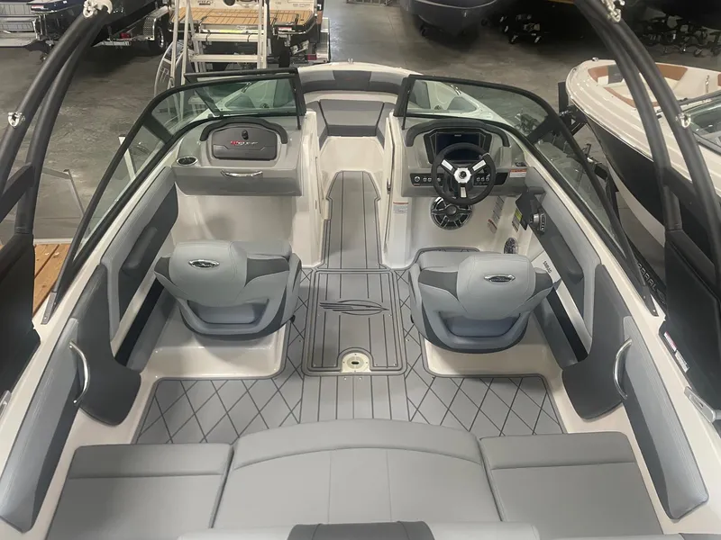 Slide: The Image of 2026 Chaparral GT Surf 1 boat interior with modern seating and steering wheel. - 2