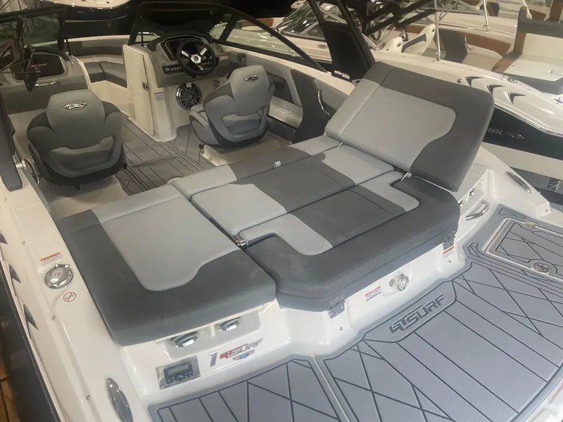 Slide: The Image of 2026 Chaparral GT Surf 1 boat interior with gray seating and modern dashboard. - 5