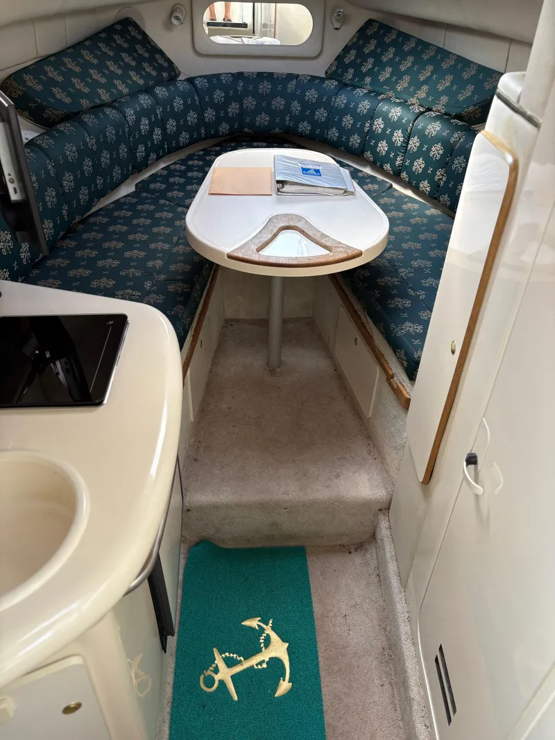 Slide: The Image of Interior of a 1996 Sea Ray 270 Sundancer boat with seating and table. - 14