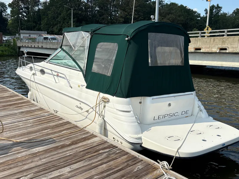 Slide: The Image of 1996 Sea Ray 270 Sundancer docked with green canopy, rear view. - 3
