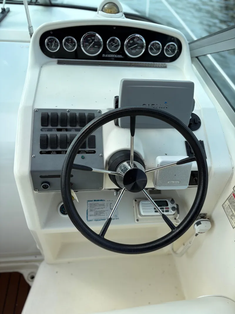 Slide: The Image of 1996 Sea Ray 270 Sundancer helm with steering wheel and instrument panel. - 4