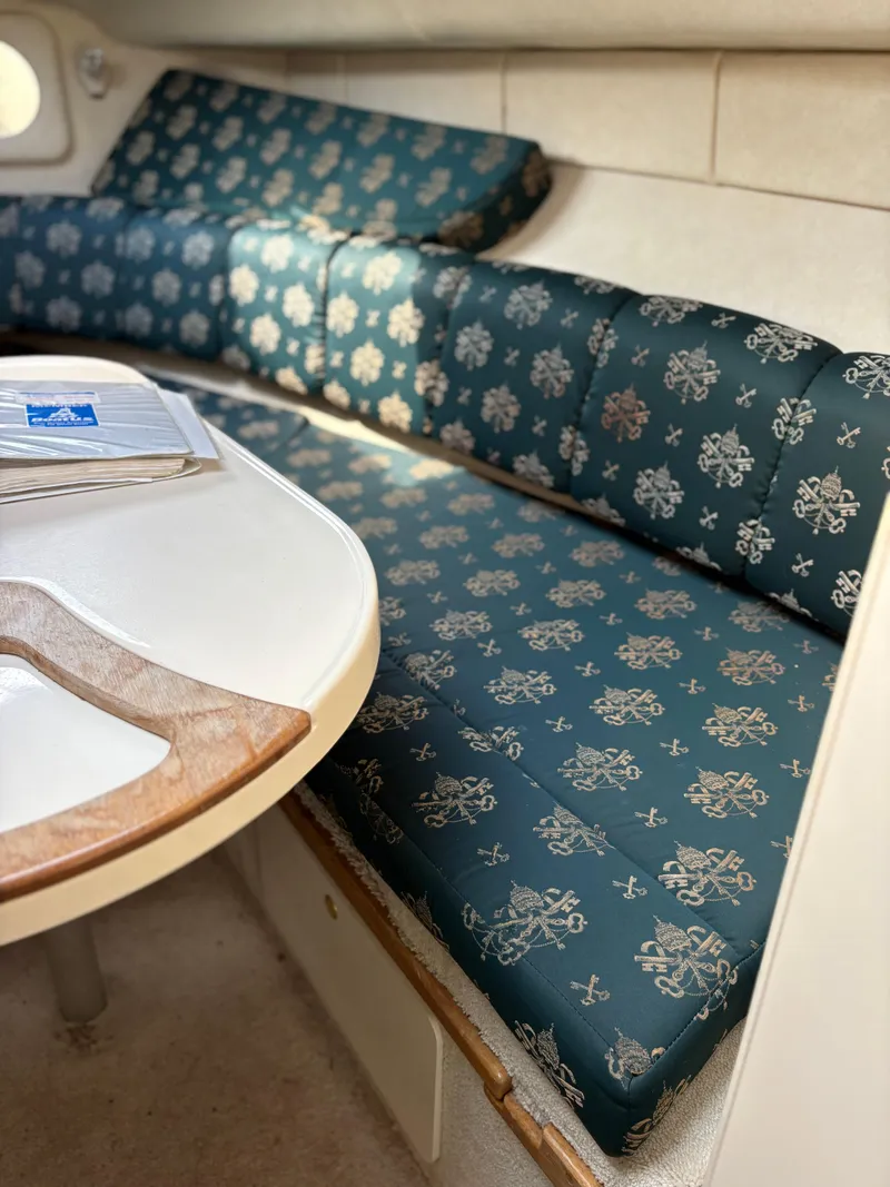 Slide: The Image of Interior of 1996 Sea Ray 270 Sundancer with patterned seating and table. - 8