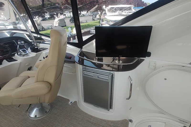 Slide: The Image of Interior of 2015 Meridian 441 Sedan yacht with helm, chair, and TV. - 11