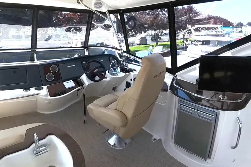 Slide: The Image of Interior of 2015 Meridian 441 Sedan yacht with helm, seating, and navigation equipment. - 12