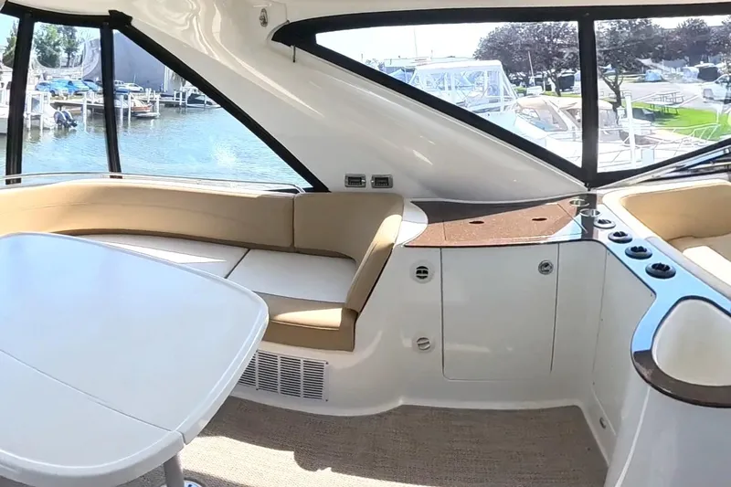 Slide: The Image of Interior of 2015 Meridian 441 Sedan yacht with seating and table, dockside view. - 13