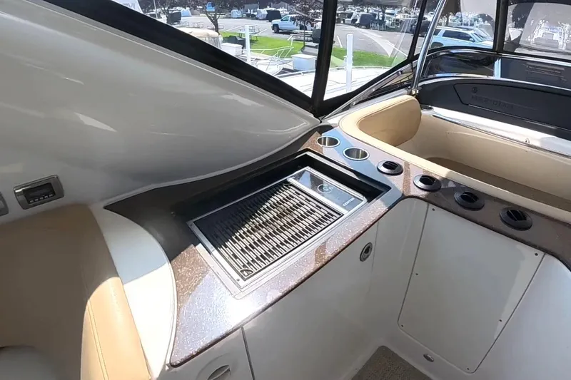 Slide: The Image of 2015 Meridian 441 Sedan yacht interior with built-in grill and cup holders. - 14