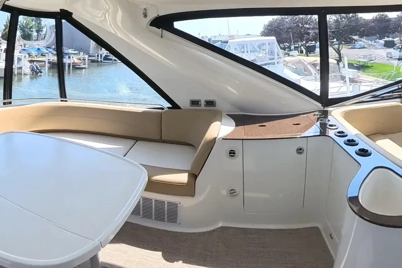 Slide: The Image of Interior of 2015 Meridian 441 Sedan yacht with seating and table, dockside view. - 15
