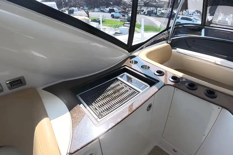Slide: The Image of 2015 Meridian 441 Sedan yacht interior with built-in grill and cup holders. - 16