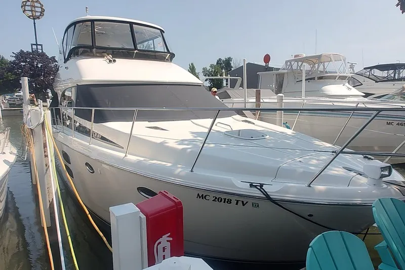 Slide: The Image of 2015 Meridian 441 Sedan yacht docked at marina, sunny day, side view. - 2