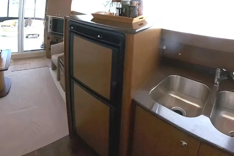 Slide: The Image of Interior of 2015 Meridian 441 Sedan yacht with kitchen sink and refrigerator. - 29