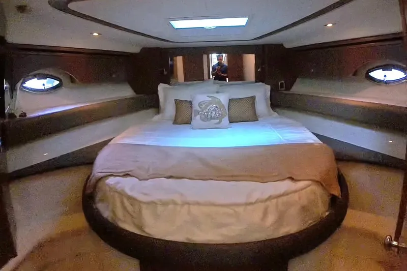 Slide: The Image of Luxurious bedroom interior of 2015 Meridian 441 Sedan yacht with elegant bedding and porthole windows. - 30