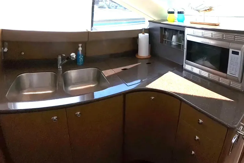 Slide: The Image of 2015 Meridian 441 Sedan kitchen with double sink, microwave, and modern cabinetry. - 35