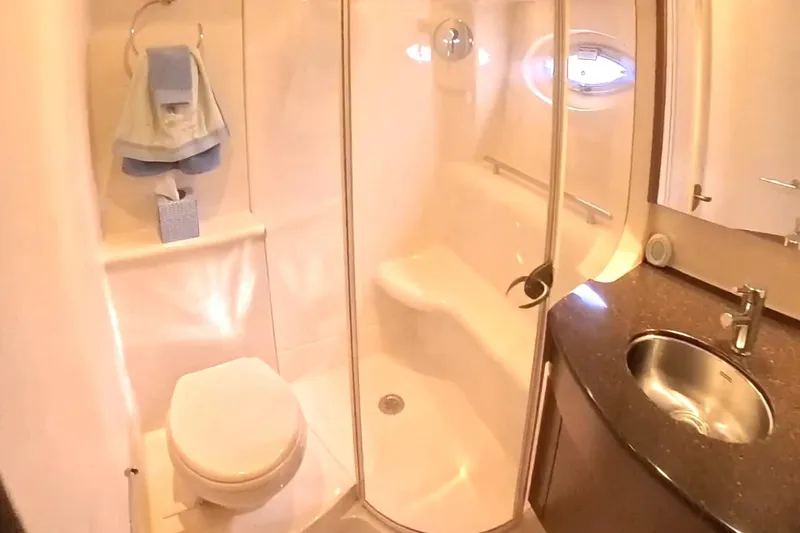 Slide: The Image of Luxurious bathroom in 2015 Meridian 441 Sedan yacht with shower, sink, and toilet. - 37