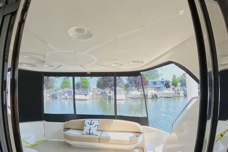 Slide: The Image of Interior view of 2015 Meridian 441 Sedan yacht with marina backdrop. - 7