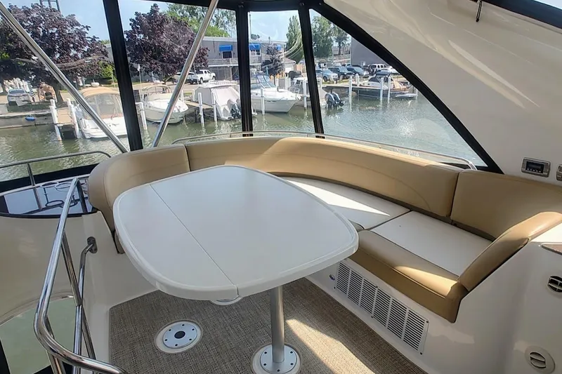 Slide: The Image of Interior of 2015 Meridian 441 Sedan yacht with seating and table, docked at marina. - 9