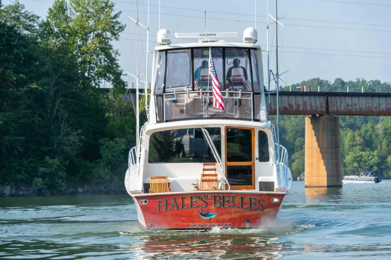 Slide: The Image of 1997 Ocean Yachts 60 Sport Fish boat on water, rear view, near bridge. - 10