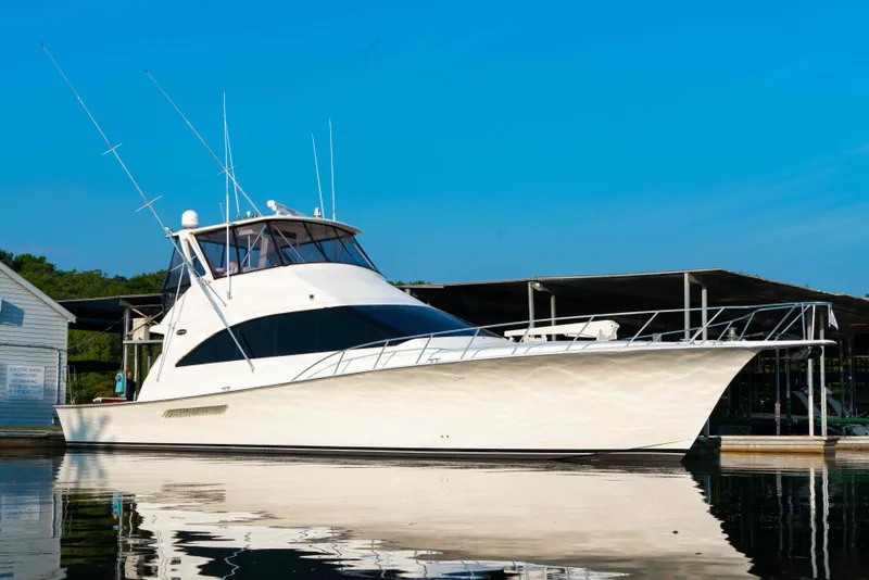 Slide: The Image of 1997 Ocean Yachts 60 Sport Fish boat docked under clear blue sky. - 13