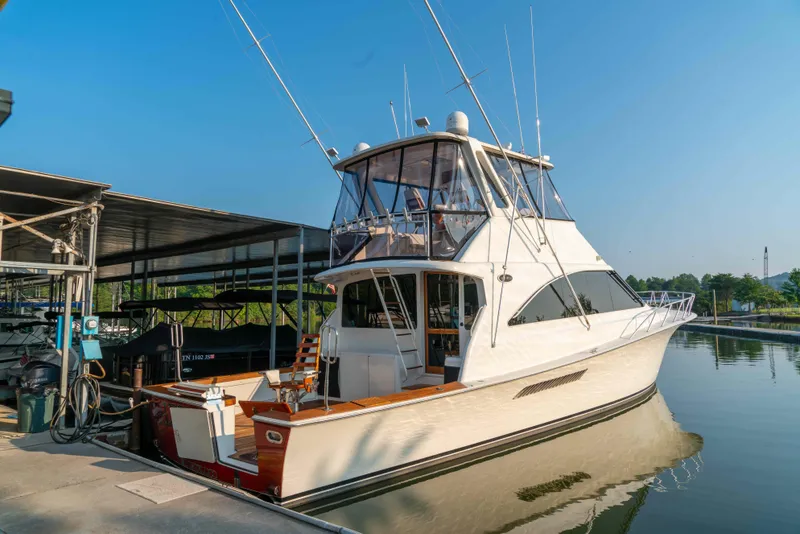 Slide: The Image of 1997 Ocean Yachts 60 Sport Fish docked at marina under clear blue sky. - 18