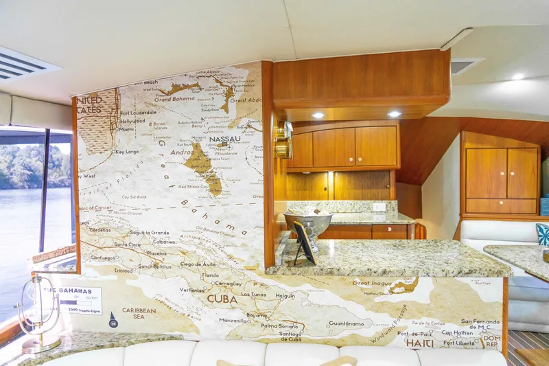 Slide: The Image of Interior of 1997 Ocean Yachts 60 Sport Fish with Caribbean map decor and wooden cabinetry. - 24