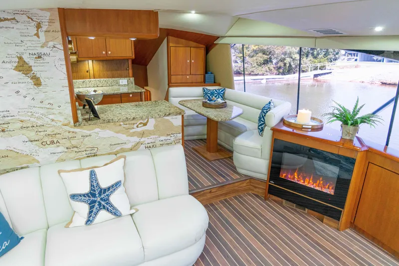 Slide: The Image of Luxurious interior of 1997 Ocean Yachts 60 Sport Fish with elegant seating and fireplace. - 25