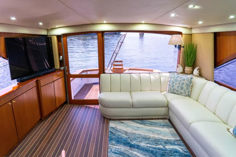 Slide: The Image of Luxurious interior of 1997 Ocean Yachts 60 Sport Fish with white sofa and large TV. - 28