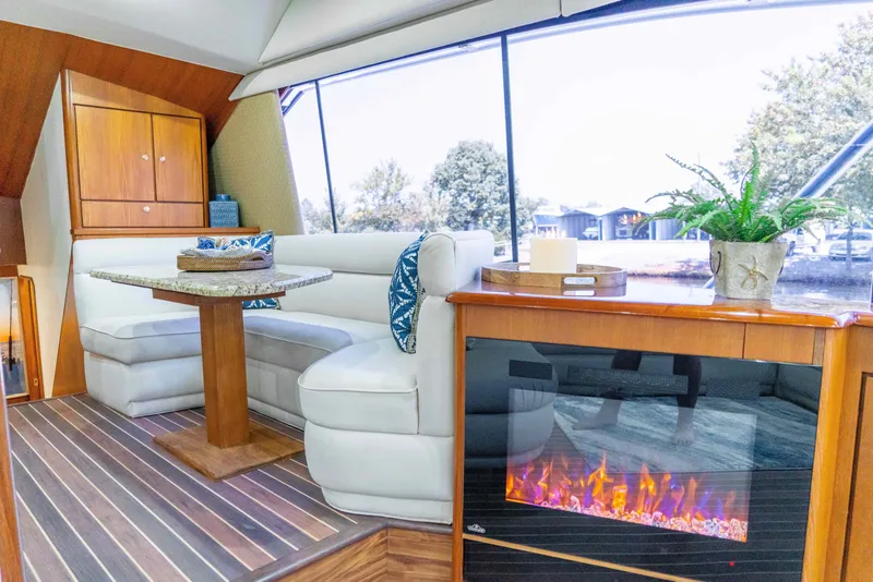 Slide: The Image of Luxurious interior of 1997 Ocean Yachts 60 Sport Fish with cozy seating and fireplace. - 33