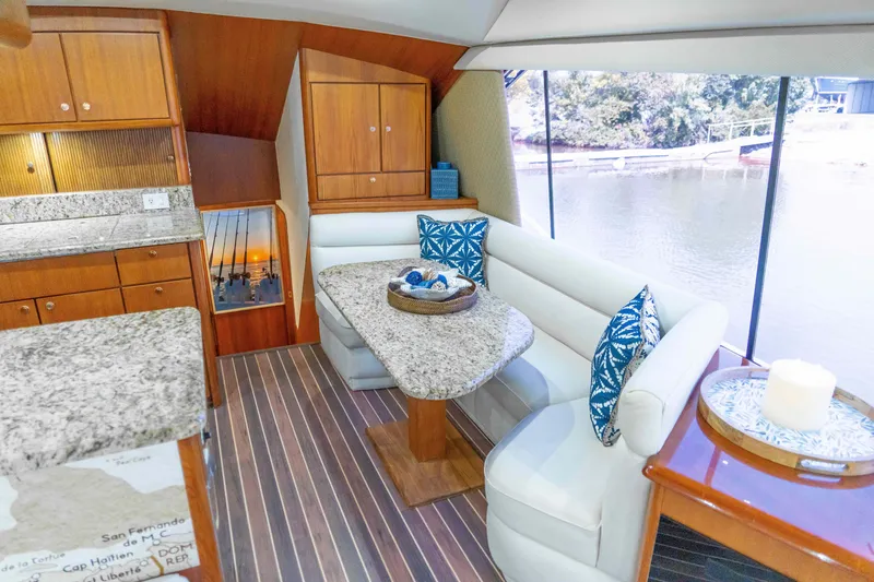 Slide: The Image of Interior of 1997 Ocean Yachts 60 Sport Fish with elegant dining area and waterfront view. - 34