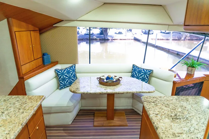 Slide: The Image of Interior of 1997 Ocean Yachts 60 Sport Fish with elegant seating and table. - 35