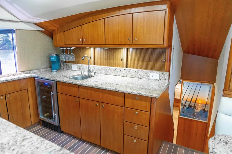 Slide: The Image of 1997 Ocean Yachts 60 Sport Fish kitchen with wooden cabinets and granite countertops. - 37