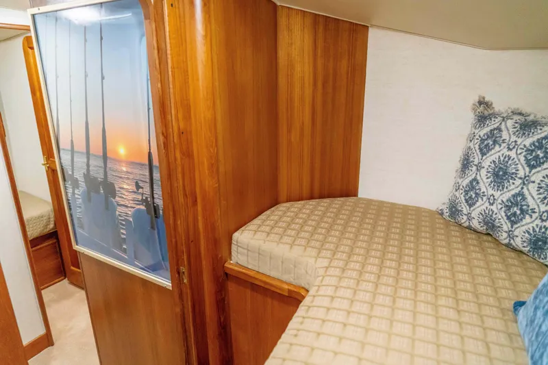 Slide: The Image of Interior cabin of 1997 Ocean Yachts 60 Sport Fish with cozy bedding and wooden finish. - 41