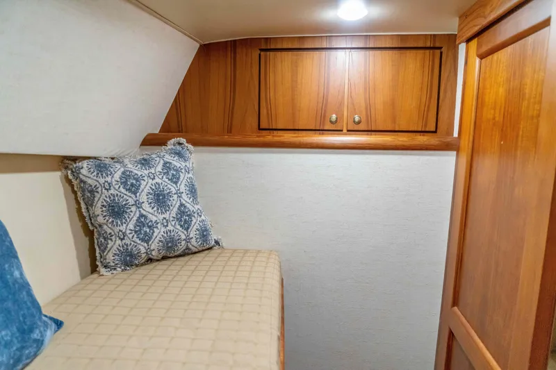 Slide: The Image of Cozy cabin interior of 1997 Ocean Yachts 60 Sport Fish with wooden cabinets and patterned pillows. - 42