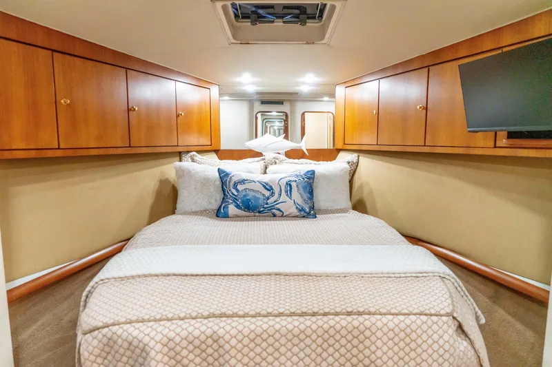 Slide: The Image of Luxurious bedroom interior of 1997 Ocean Yachts 60 Sport Fish with elegant wood cabinetry. - 44