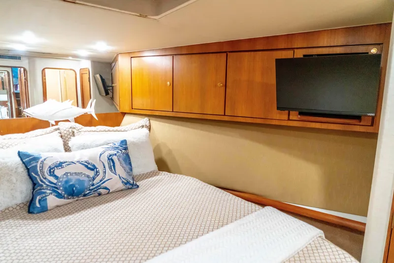 Slide: The Image of Luxurious cabin interior of 1997 Ocean Yachts 60 Sport Fish with cozy bedding and TV. - 46