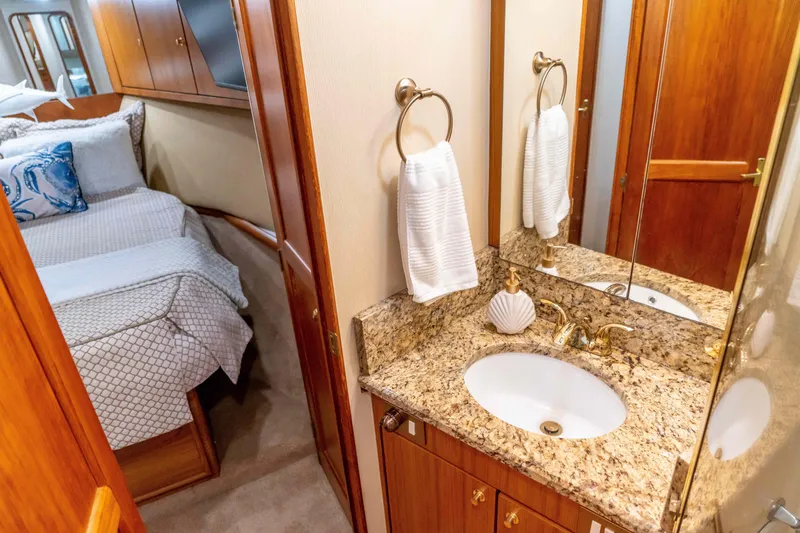 Slide: The Image of Luxurious 1997 Ocean Yachts 60 Sport Fish interior with elegant bathroom and cozy bedroom. - 49