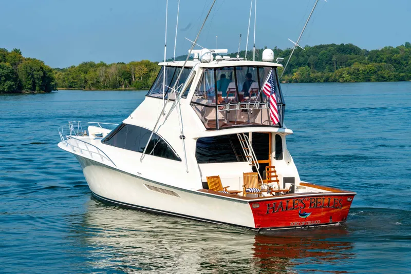 Slide: The Image of 1997 Ocean Yachts 60 Sport Fish boat cruising on a serene lake. - 7