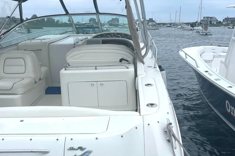 Slide: The Image of 2001 Sea Ray 290 Amberjack boat interior with seating, docked in a marina. - 10