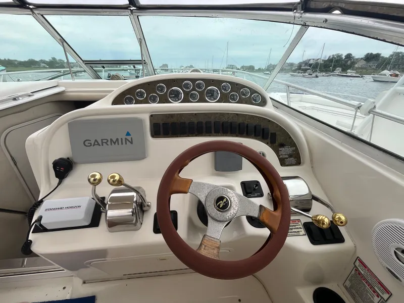 Slide: The Image of 2001 Sea Ray 290 Amberjack helm with Garmin navigation and classic steering wheel. - 14