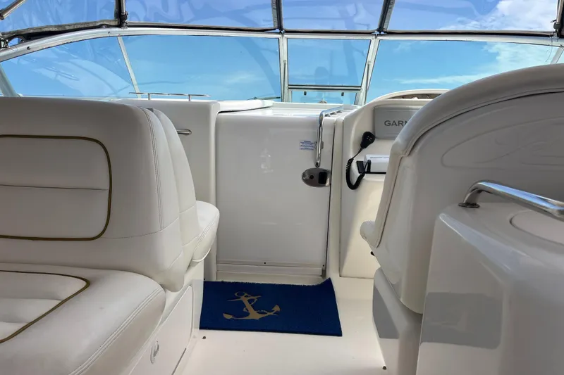 Slide: The Image of Interior of 2001 Sea Ray 290 Amberjack boat with white seating and clear canopy. - 23
