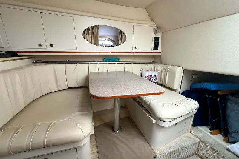 Slide: The Image of Interior of 2001 Sea Ray 290 Amberjack with cream seating and dining table. - 25