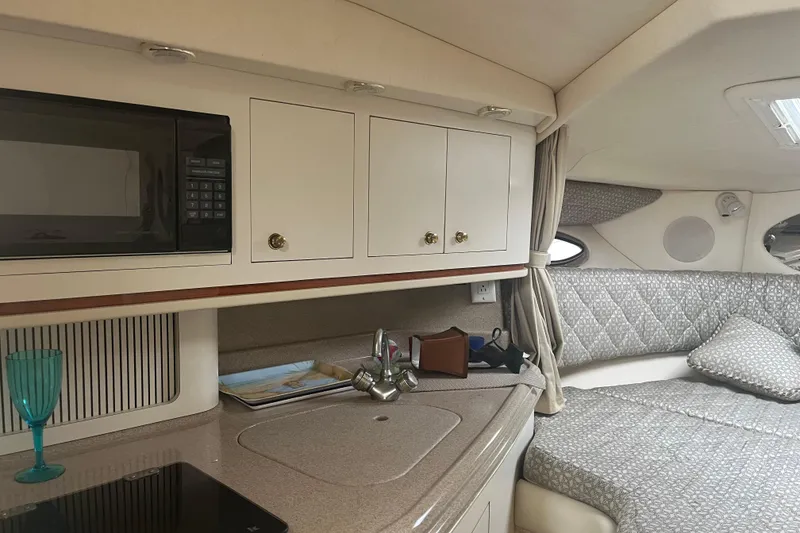 Slide: The Image of Interior of 2001 Searay 29 Amber boat with kitchenette and cozy sleeping area. - 34