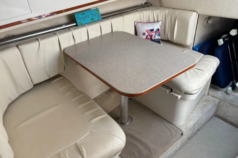 Slide: The Image of 2001 Searay 29 Amber interior with beige seating and dining table. - 36