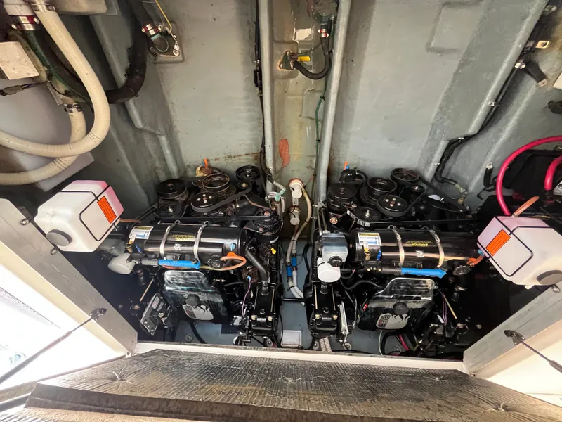 Slide: The Image of Engine compartment of a 2001 Sea Ray 290 Amberjack boat, showcasing dual engines. - 40