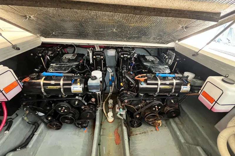 Slide: The Image of Engine compartment of a 2001 Sea Ray 290 Amberjack, showcasing dual engines and mechanical components. - 41