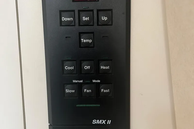 Slide: The Image of Control panel of a 2001 Searay 29 Amber boat with temperature and fan settings. - 42