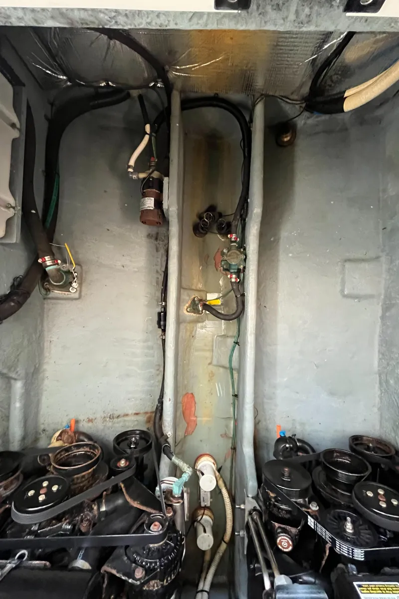 Slide: The Image of Engine compartment of a 2001 Sea Ray 290 Amberjack boat, showing mechanical components and wiring. - 43