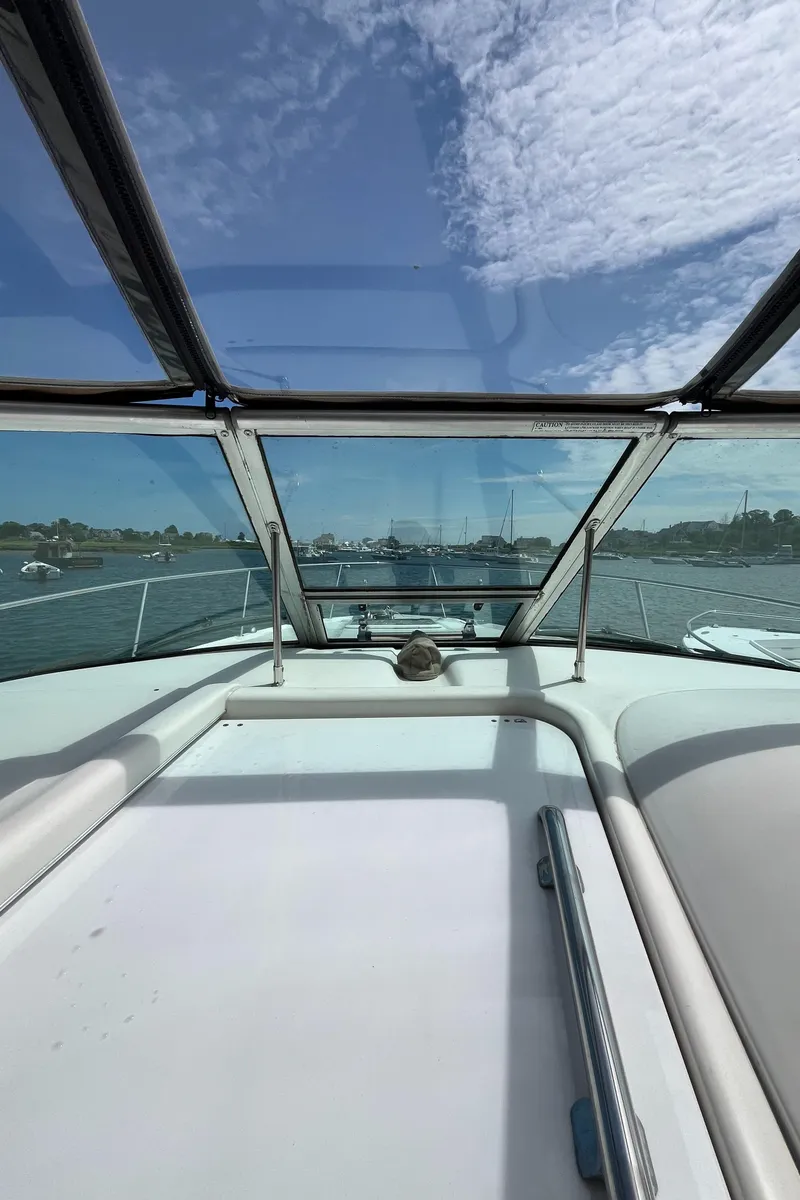 Slide: The Image of 2001 Sea Ray 290 Amberjack boat interior with clear sky and water view. - 8