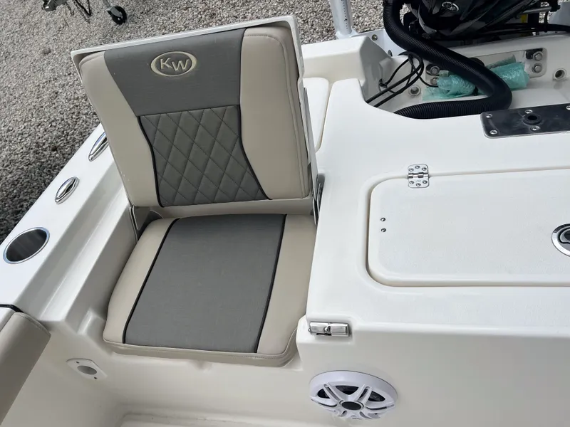 Slide: The Image of 2026 Key West 230 Bay Reef boat seat with cup holders and speaker. - 13