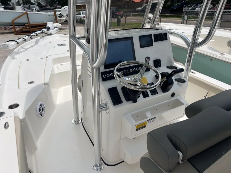 Slide: The Image of 2026 Key West 230 Bay Reef boat interior with steering console and seating. - 15