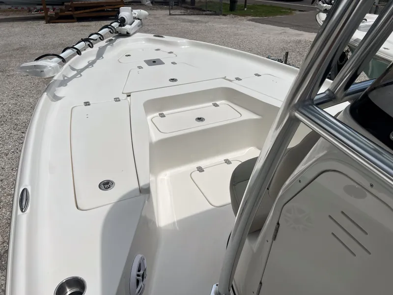 Slide: The Image of 2026 Key West 230 Bay Reef boat deck with storage compartments and trolling motor. - 16