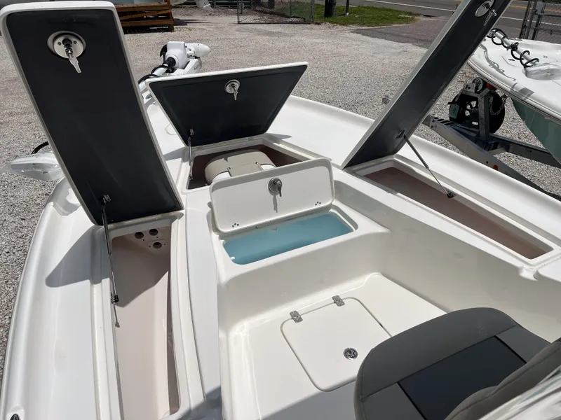 Slide: The Image of 2026 Key West 230 Bay Reef boat with open storage compartments and seating. - 17